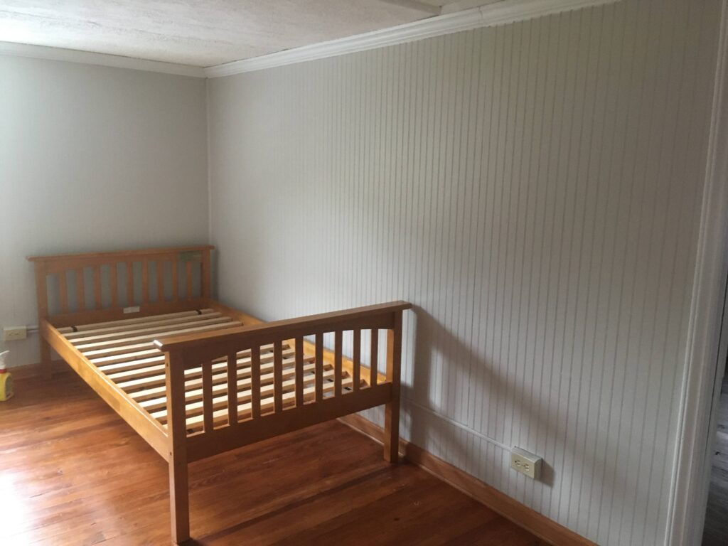 wood paneling painted beige in teen bedroom reno