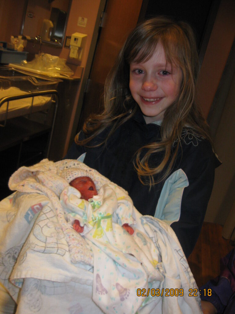 8 year old holds her stillborn sister and cries