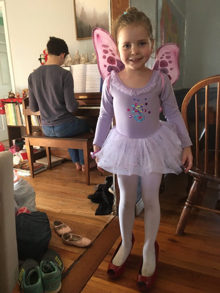 girl in purple ballerina outfit with fairy wings