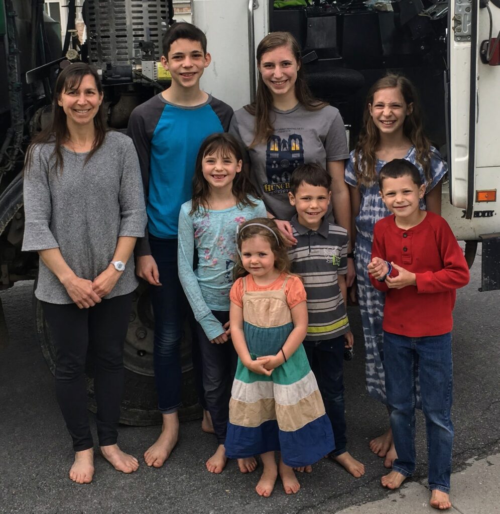 family standing in front of a garbage truck