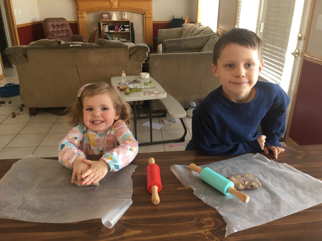 2 year old girl and 6 year old boy playing play doh