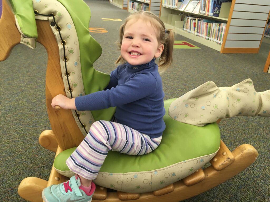 2 year old girl on a rocking horse