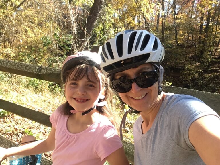 mom and daughter go on a bike ride together