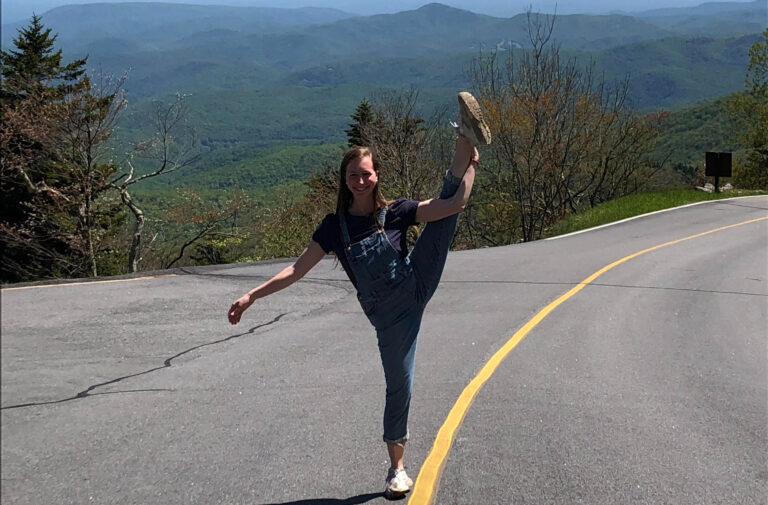 girl doing the splits in the road at Grandfather Mountain