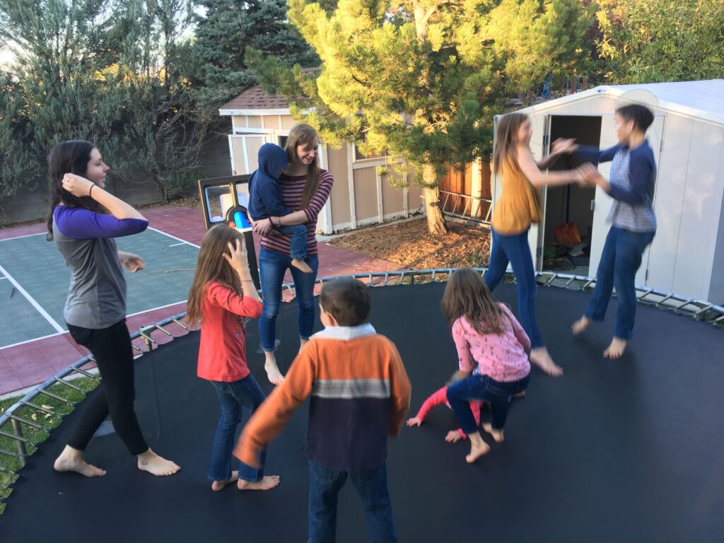 9 kids play on a trampoline to get exercise without taking any extra time to.