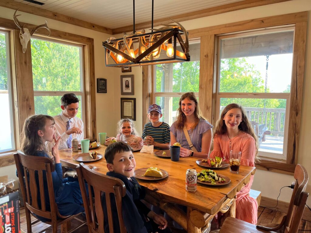 kids eating dinner around a farmhouse table