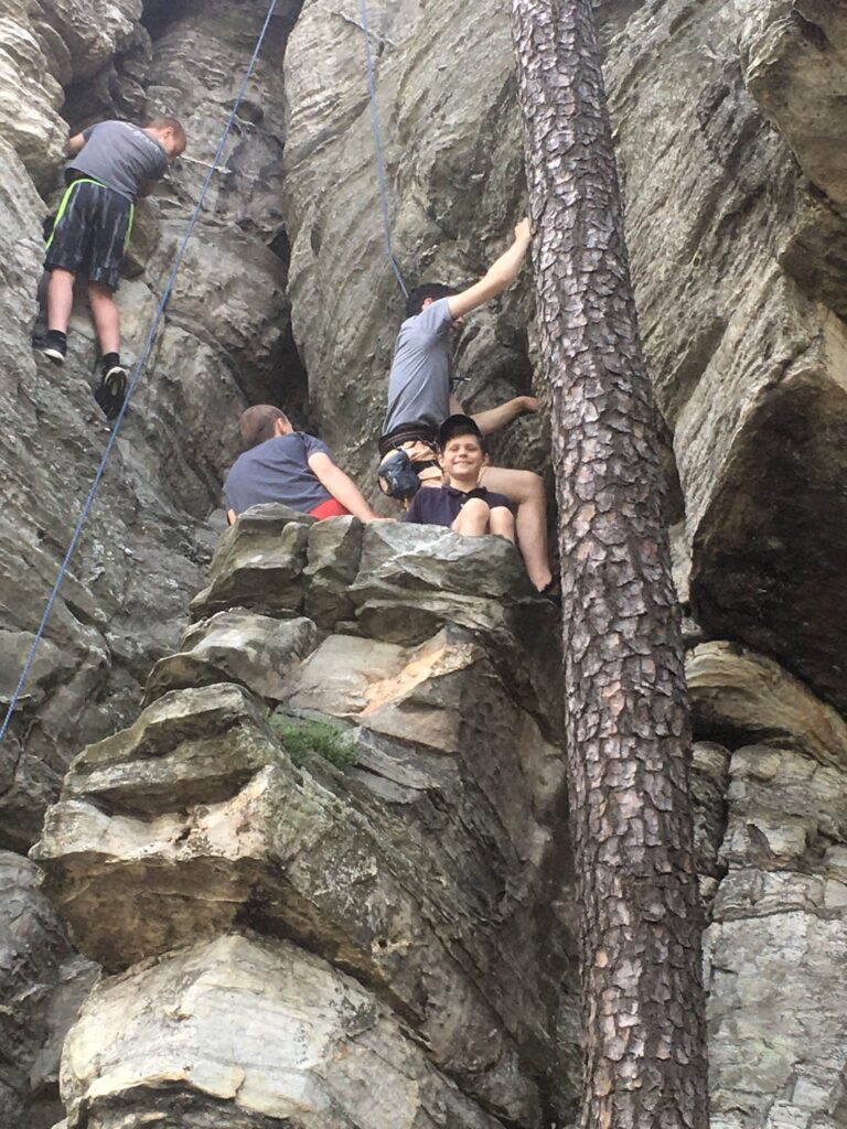 boys rock climbing at Pilot Mountain