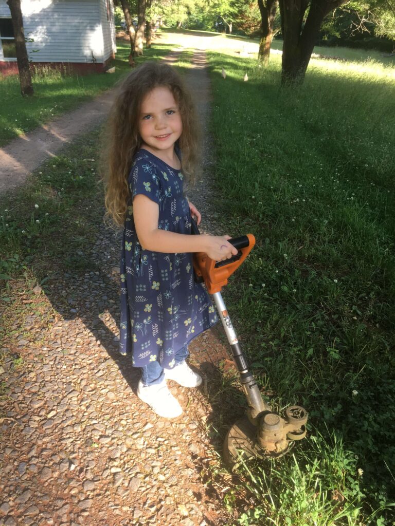 5 year old weed whacking the driveway