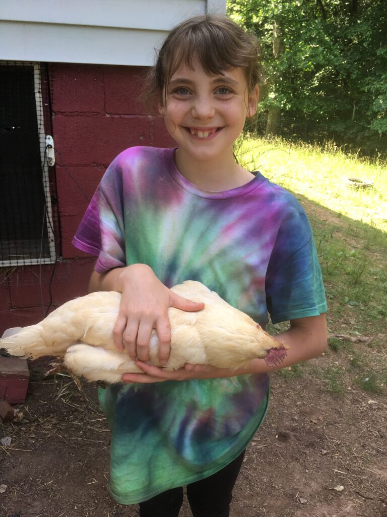11 year old holds her dead chicken
