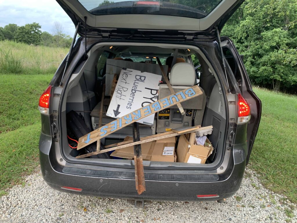 trunk of a minivan with blueberry signs in it