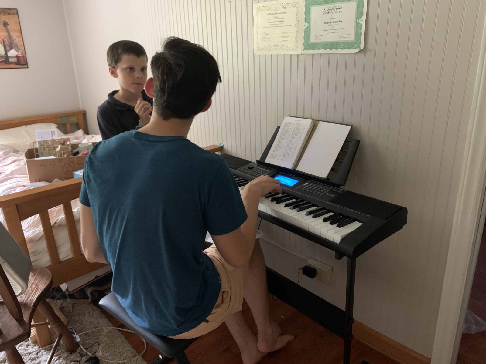 brothers playing a little digital piano