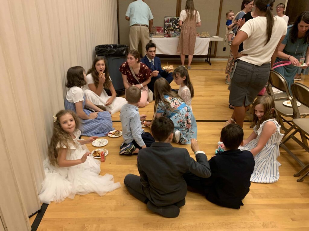 kids eating refreshments on the floor at a church baptism