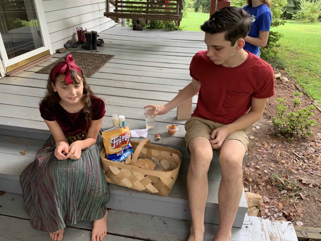 boy and girl share a picnic lunch