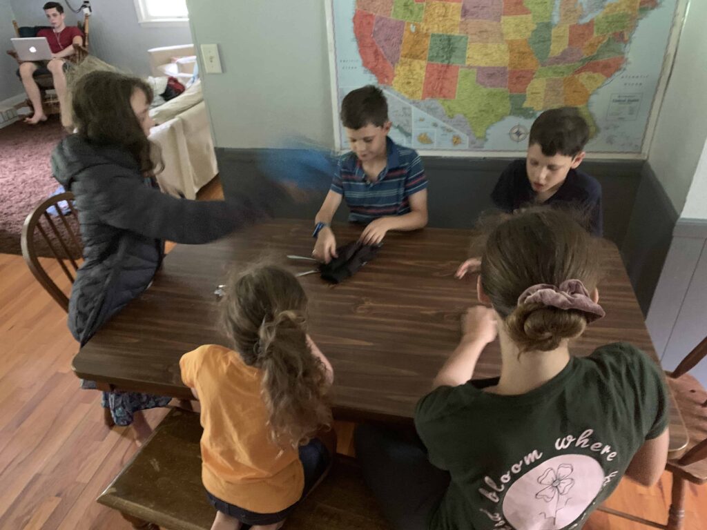 kids playing the candy bar game around the table