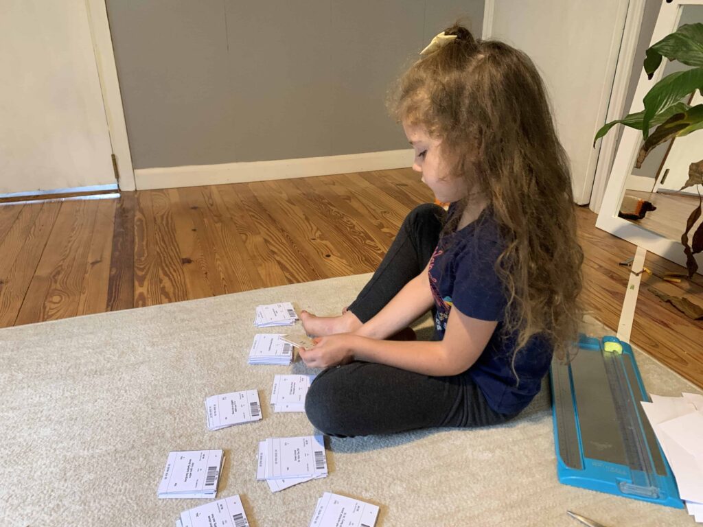 6 year old organizing tags for a clothing sale