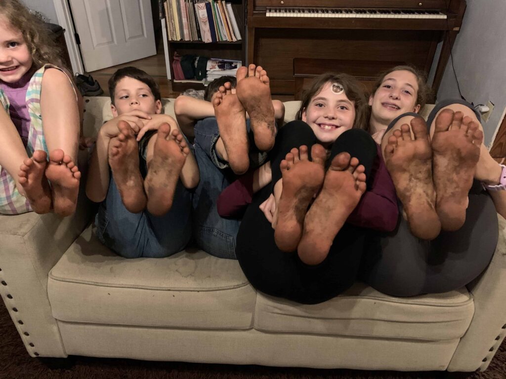 5 kids showing their dirty feet